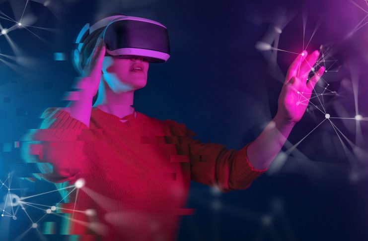 Metaverse technology concept. Woman with VR virtual reality goggles. Futuristic lifestyle.