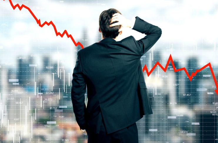 Back view of stressed young businessman looking at downward red arrow on blurry city background. Decrease, stats and economy concept. Multiexposure
