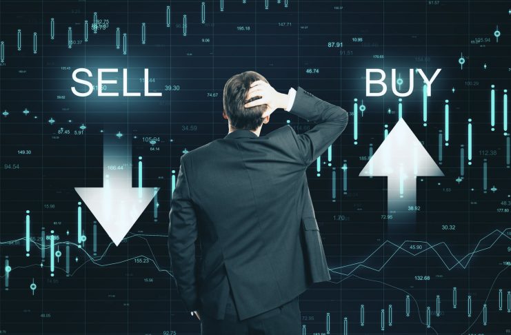 Back view of thoughtful businessman on creative buy sell forex chart background. Market and invest concept