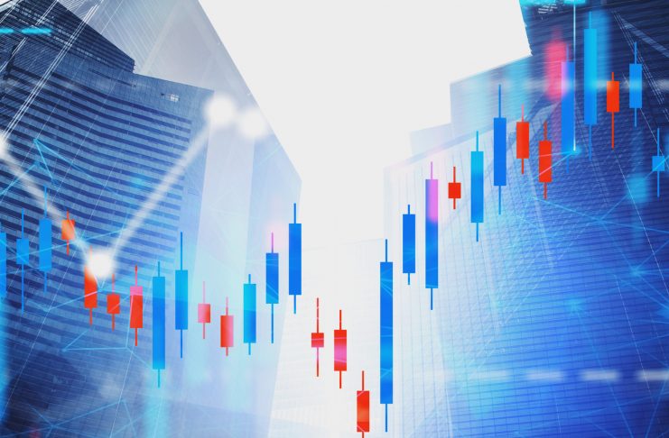 Financial graphs and network hologram over modern city background with skyscrapers. Concept of trading and stock market. Toned image double exposure