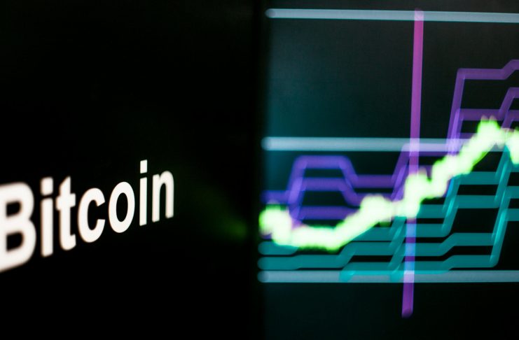Bitcoin Cryptocurrency token. Rise in price and Growth of quotations, the green graph up. The behavior of the cryptocurrency exchanges, concept. Modern financial technologies.