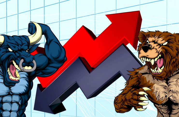 Financial concept of a cartoon bear fighting a bull mascot characters in front of a stock market or profit graph